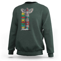 Forest green crewneck sweatshirt with multicolor totem pole graphic and 'Alaska' text