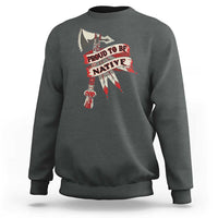 Dark gray crewneck sweatshirt with “PROUD TO BE NATIVE” graphic on chest