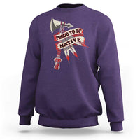 Purple crewneck sweatshirt with “PROUD TO BE NATIVE” graphic on chest