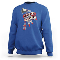 Blue crewneck sweatshirt with “PROUD TO BE NATIVE” graphic on chest