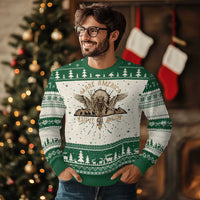 Ugly Christmas sweater in green and cream with eagle graphic and patterned yoke