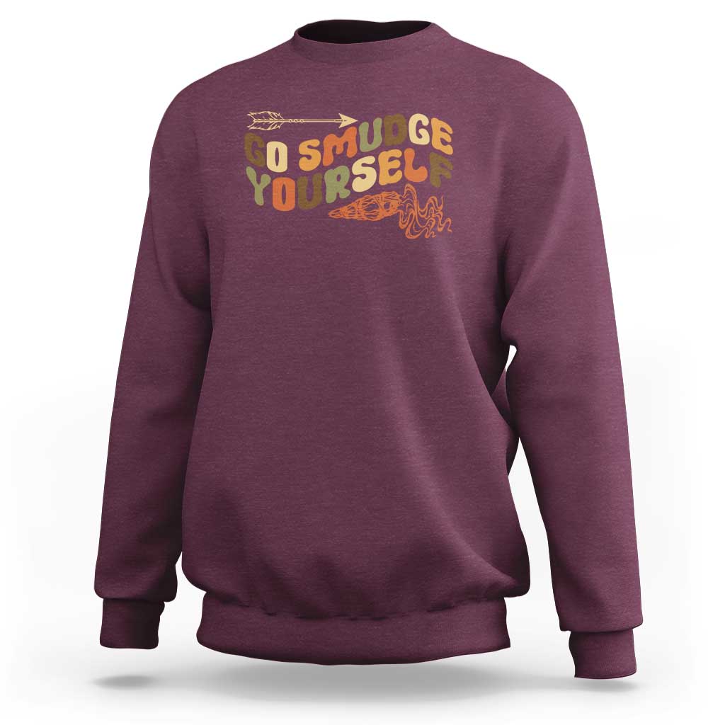 Maroon crewneck sweatshirt with “Go Smudge Yourself” graphic on the chest