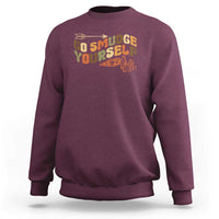 Maroon crewneck sweatshirt with “Go Smudge Yourself” graphic on the chest