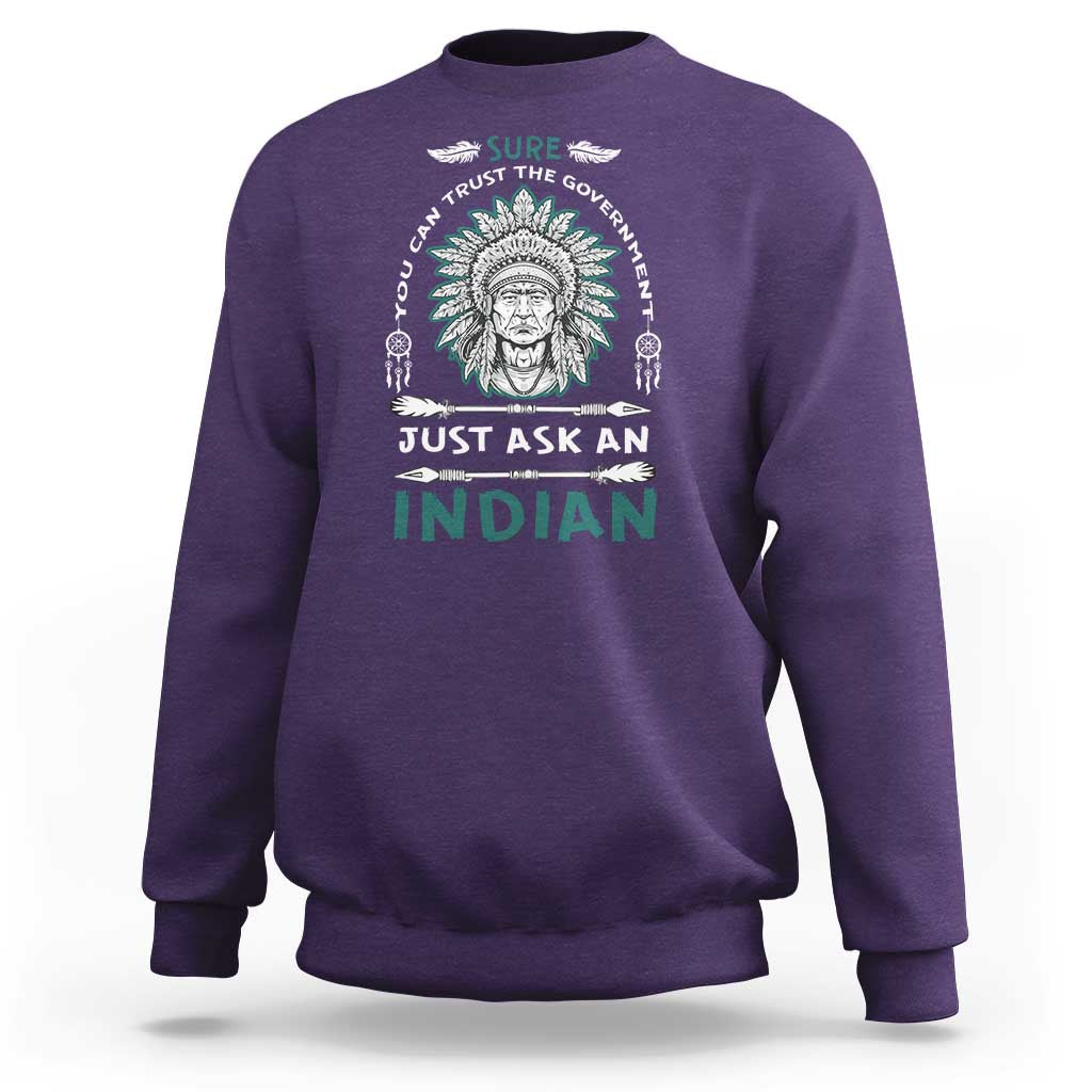 Purple crewneck sweatshirt with Native American head graphic and slogan print on chest