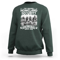 Dark green crewneck sweatshirt with front Native-style graphic and Homeland Security text