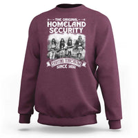 Maroon crewneck sweatshirt with front Native-style graphic and bold Homeland Security text
