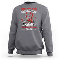 Gray sweatshirt with front graphic text and Native American-style figures in red and white