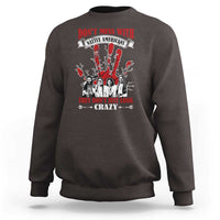 Dark brown sweatshirt with front graphic text and Native American-style figures in red and white