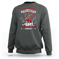 Dark heather gray sweatshirt with front graphic text and Native American-style figures in red and white