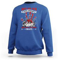 Blue sweatshirt with front graphic text and Native American-style figures in red and white