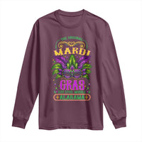 Maroon long-sleeve shirt with colorful Mardi Gras graphic and floral ornament logo