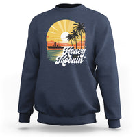 Navy sweatshirt with “Honey Moonin” beach graphic and palm tree print