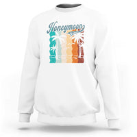 White crewneck sweatshirt with 'Honeymoon' beach graphic panel at chest