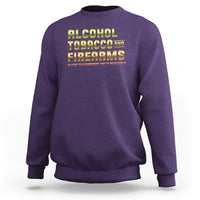 Purple crewneck sweatshirt with Alcohol Tobacco Firearms front graphic.
