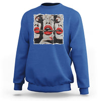 Royal blue crewneck sweatshirt with front graphic of stylized faces and red lips