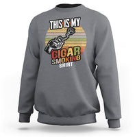 Light gray crewneck sweatshirt with front graphic featuring cigar-smoking text