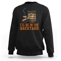 Black sweatshirt with whiskey glass and cigar graphic; text 'I'll be in the backyard'.