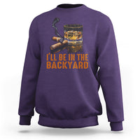 Purple sweatshirt with whiskey glass and cigars illustration; 'I'll be in the backyard' text.