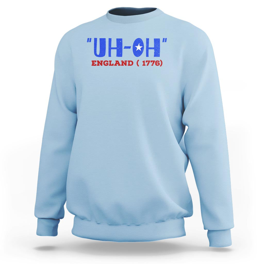 Light blue crewneck sweatshirt with 'UH-OH' England 1776 graphic, long sleeves