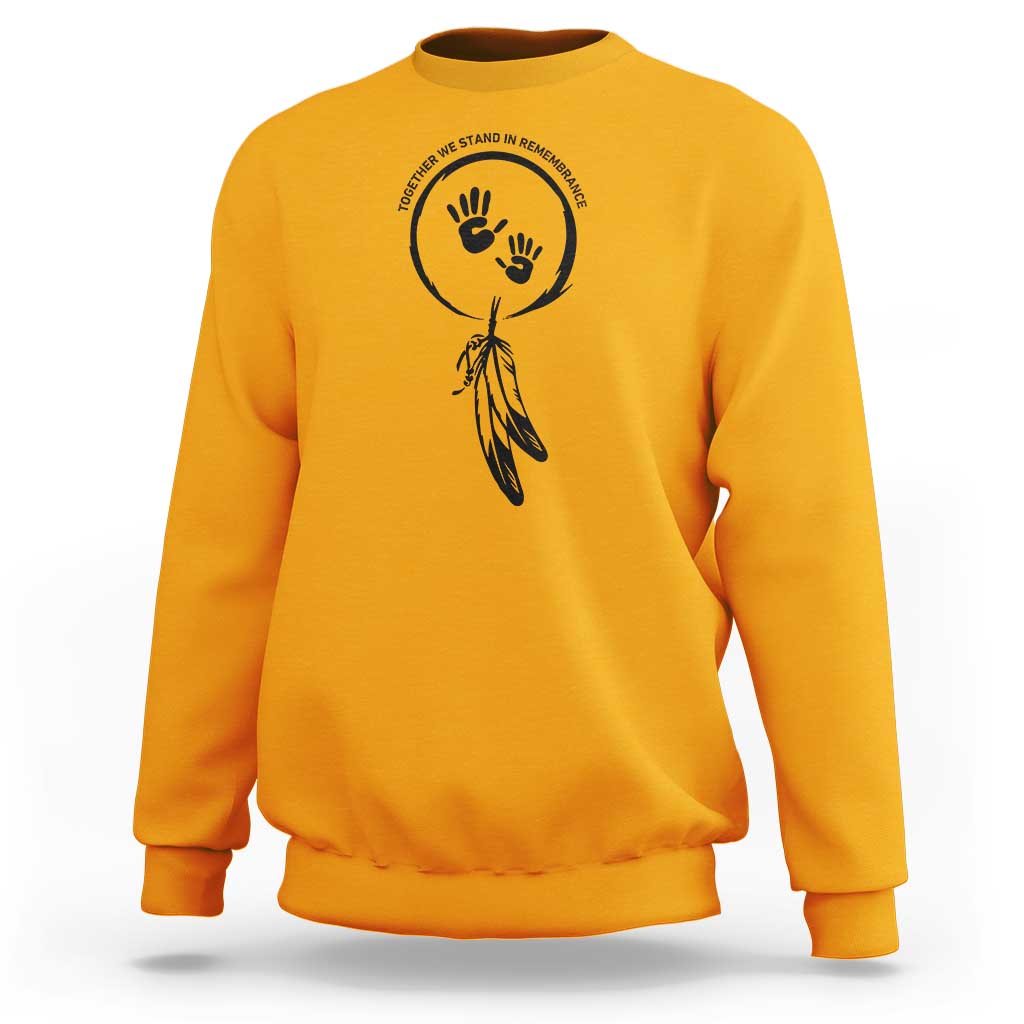 Gold sweatshirt with circular hand and dreamcatcher-style graphic on chest