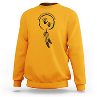 Gold sweatshirt with circular hand and dreamcatcher-style graphic on chest