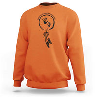 Orange sweatshirt with circular hand and dreamcatcher-style graphic on chest