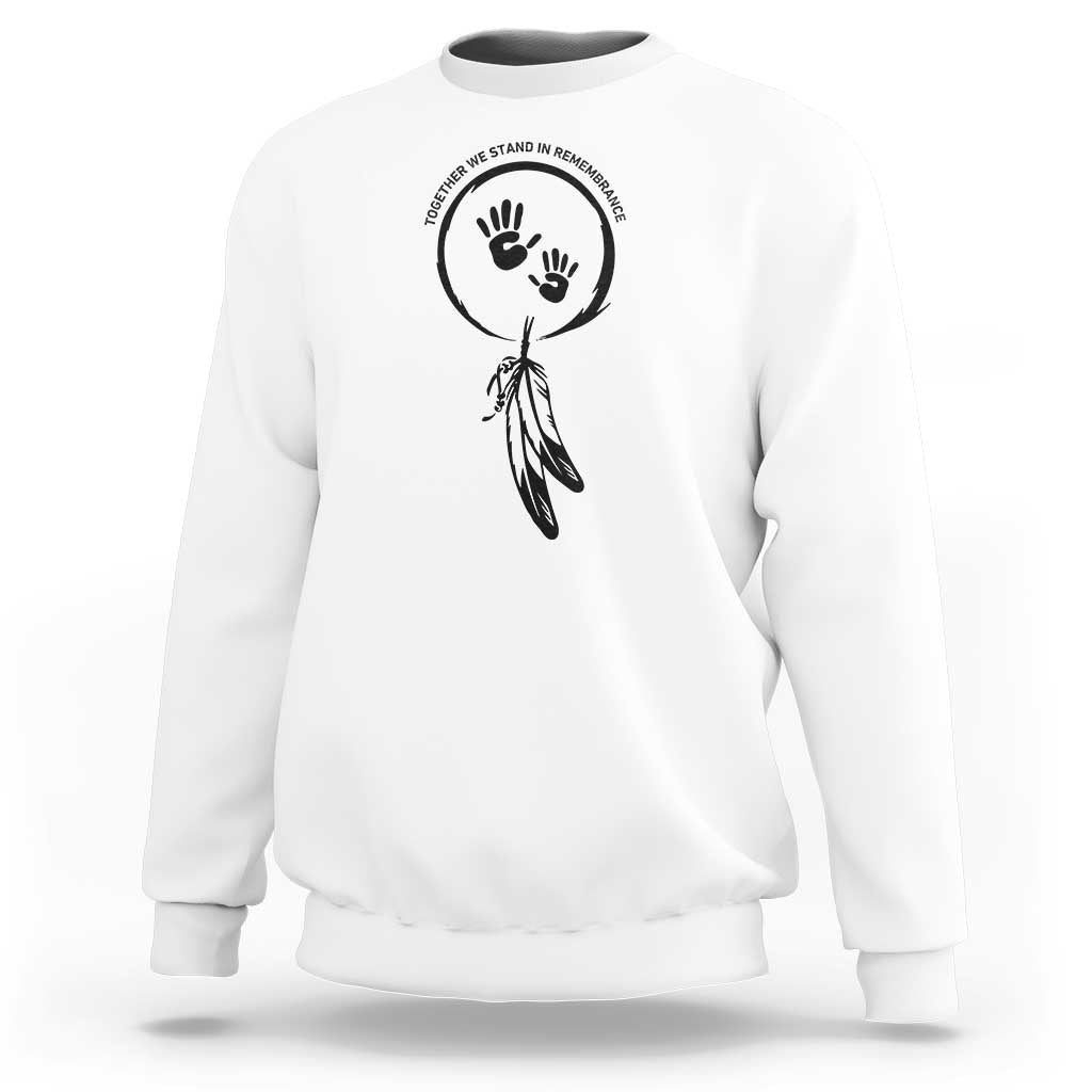 White sweatshirt with circular hand and dreamcatcher-style graphic on chest