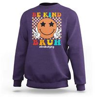 Purple crewneck sweatshirt with smiley anti-bullying graphic and "Be Kind" front text