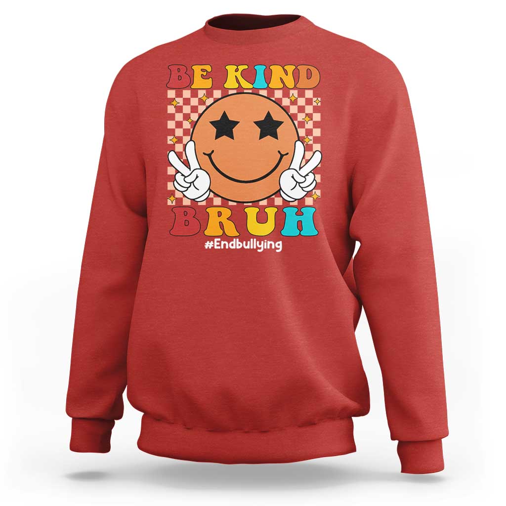 Red crewneck sweatshirt with smiley anti-bullying graphic, checkered "Be Kind" front print