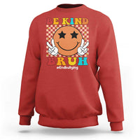Red crewneck sweatshirt with smiley anti-bullying graphic, checkered "Be Kind" front print