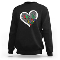 Black sweatshirt with large white heart graphic and colorful message text art