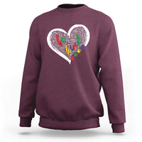 Maroon sweatshirt with large white heart graphic and colorful message text art