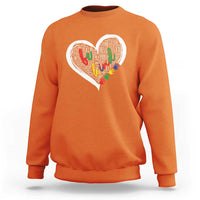 Orange sweatshirt with large white heart graphic and colorful text art