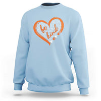 Light blue sweatshirt with orange-and-white heart anti-bullying word art on back