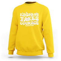 Daisy yellow crewneck sweatshirt with “Kindness Takes Courage” anti-bullying graphic