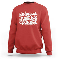 Red crewneck sweatshirt with “Kindness Takes Courage” anti-bullying graphic