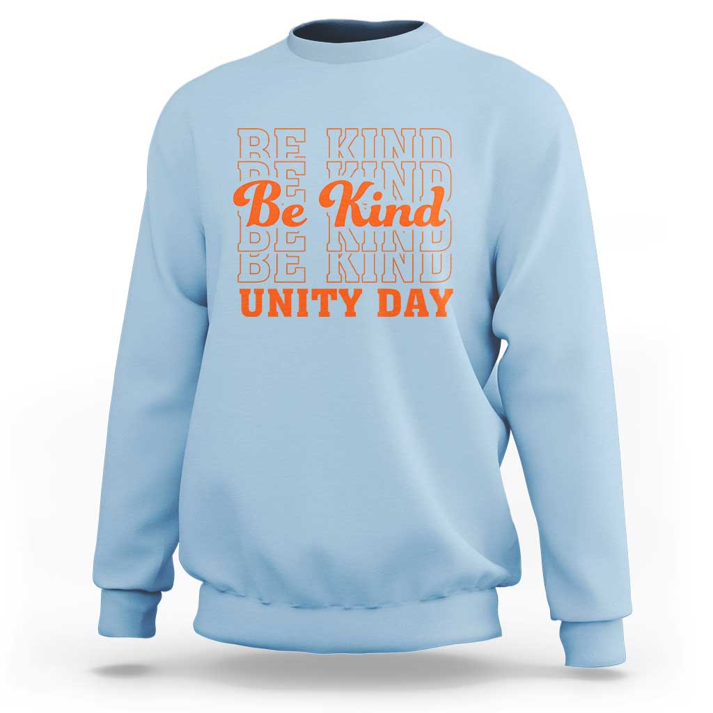 Light blue crewneck sweatshirt with “BE KIND” and “UNITY DAY” graphic text in orange and blue