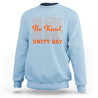 Light blue crewneck sweatshirt with “BE KIND” and “UNITY DAY” graphic text in orange and blue