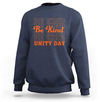 Navy crewneck sweatshirt with “BE KIND” and “UNITY DAY” graphic text in orange and blue
