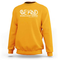 Gold sweatshirt with 'Be Kind' and 'Words Don't Rewind' anti-bullying text