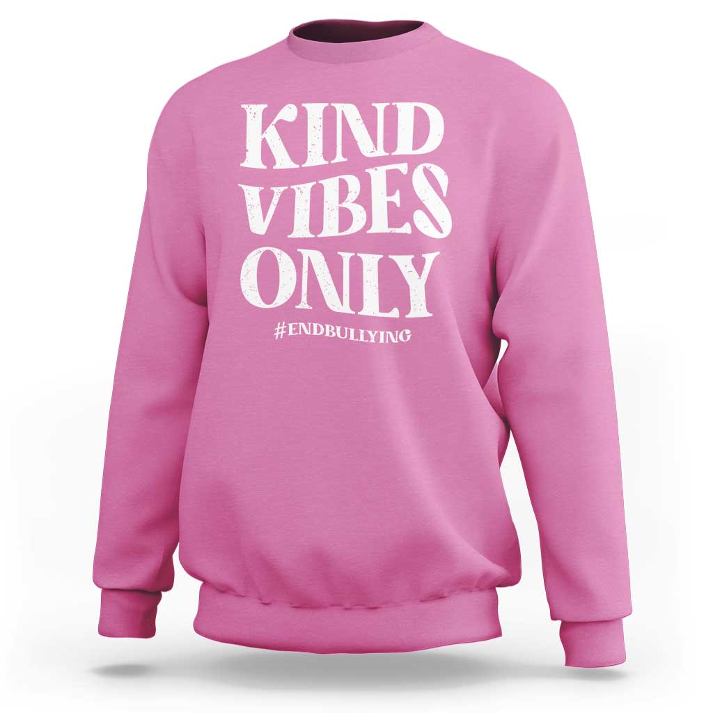 Pink sweatshirt with “KIND VIBES ONLY” slogan graphic and #END BULLYING text