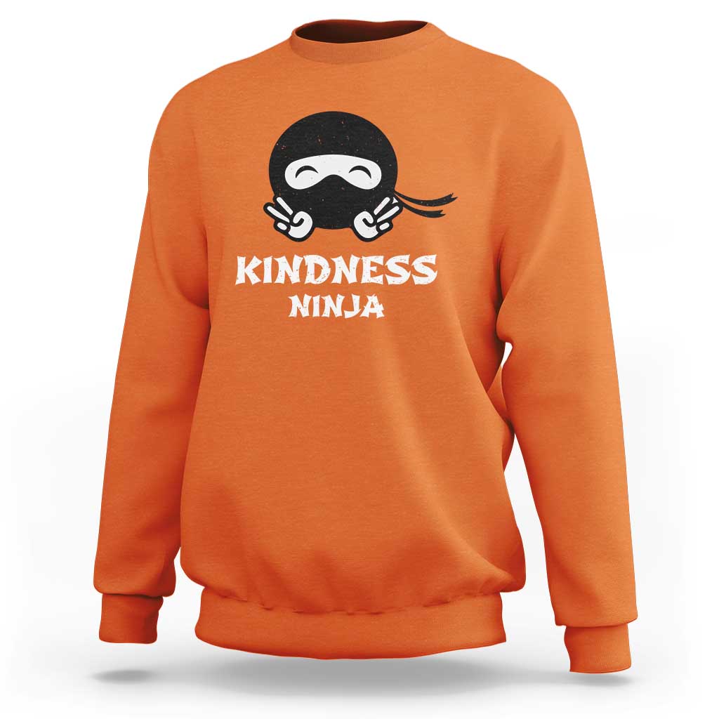 Orange sweatshirt with Kindness Ninja front graphic