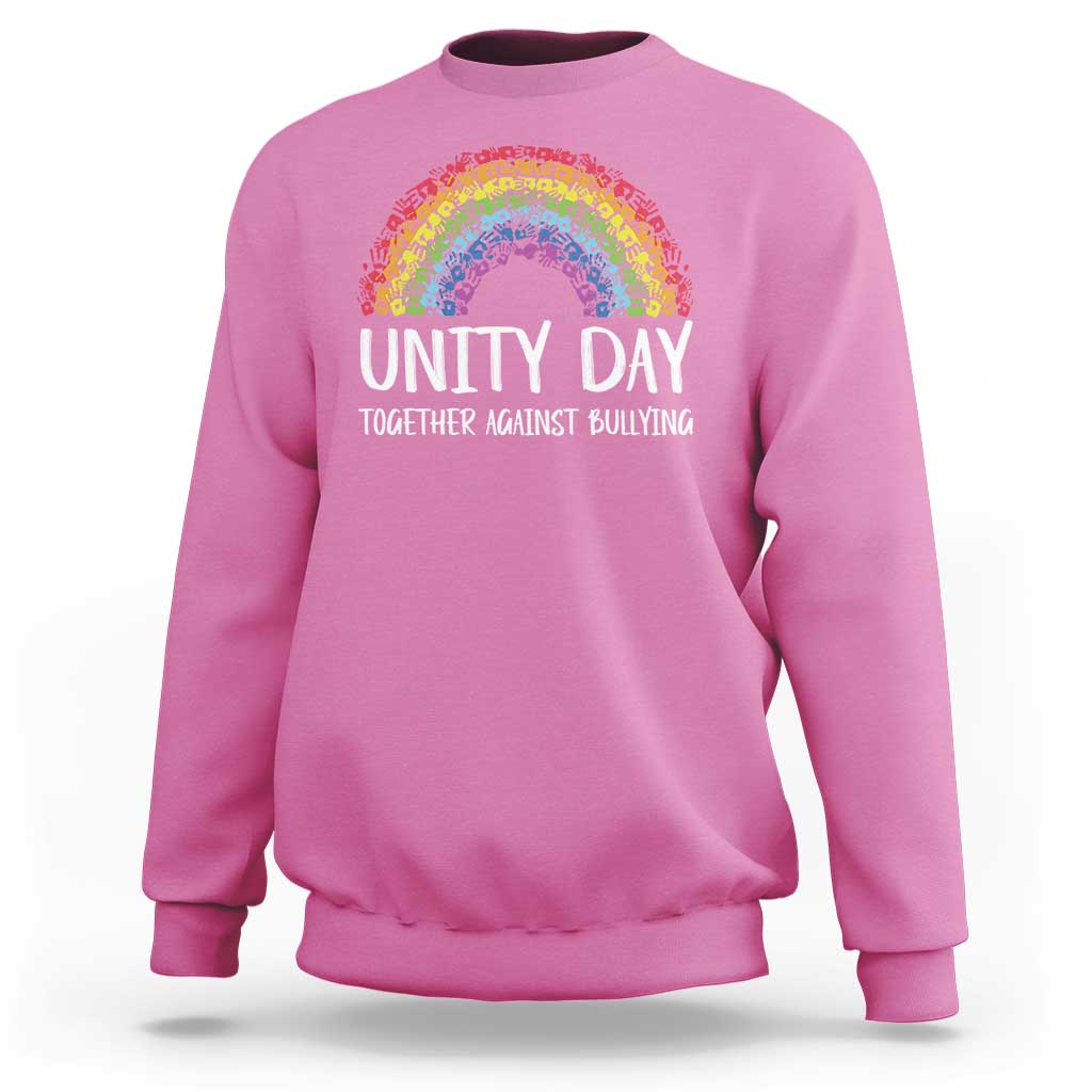Pink crewneck sweatshirt with rainbow arch graphic and “UNITY DAY” front text