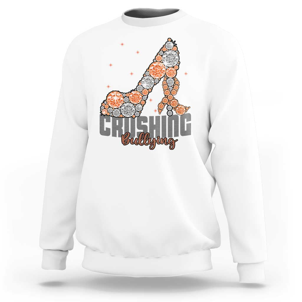 White sweatshirt with “Crushing Bullying” graphic and orange dotted ribbon