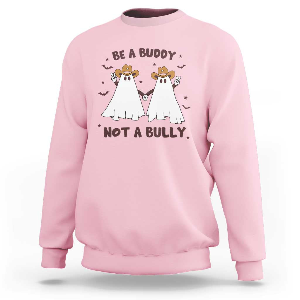 Light pink crewneck sweatshirt with “Be a Buddy Not a Bully” cowboy ghost graphic