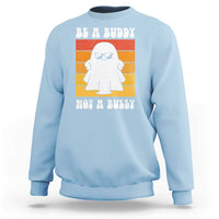 Anti-bullying sweatshirt in light blue with white ghost graphic and “Be A Buddy Not A Bully” print