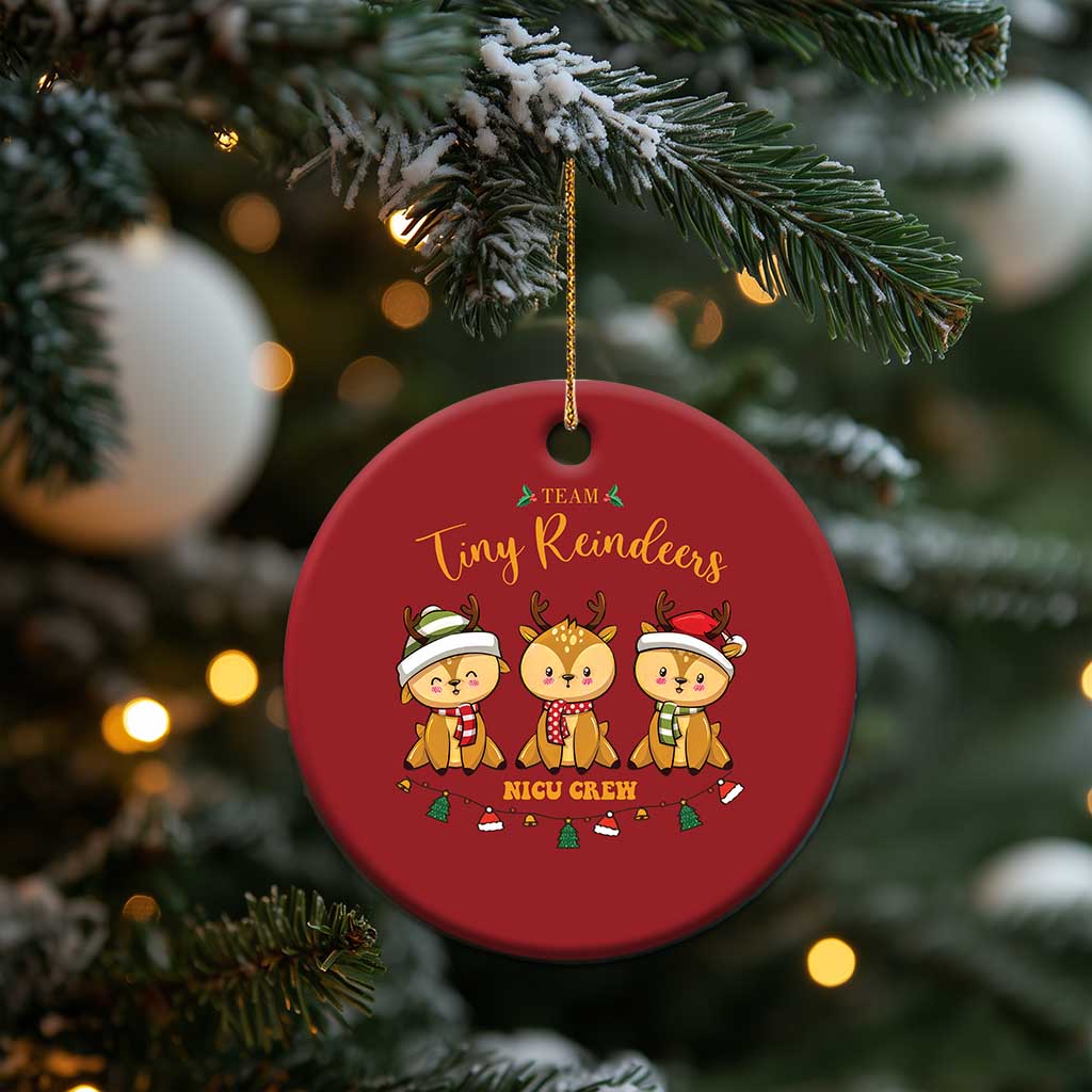 Red round Tiny Reindeers NICU Crew Christmas ornament hanging from a tree branch