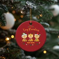 Red round Tiny Reindeers NICU Crew Christmas ornament hanging from a tree branch