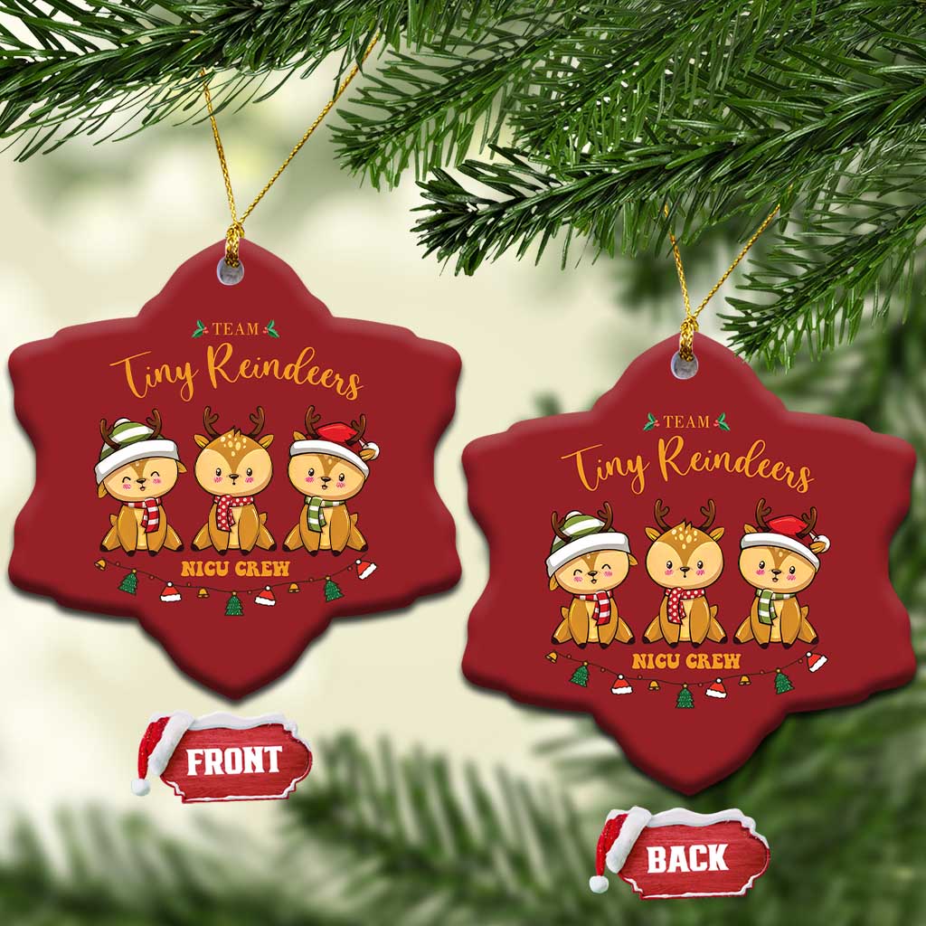 Two red heart-shaped Tiny Reindeers NICU Crew ornaments hanging from tree branches
