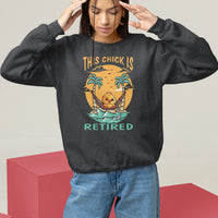 Women's black sweatshirt with “THIS CHICK IS RETIRED” palm graphic, relaxed crewneck
